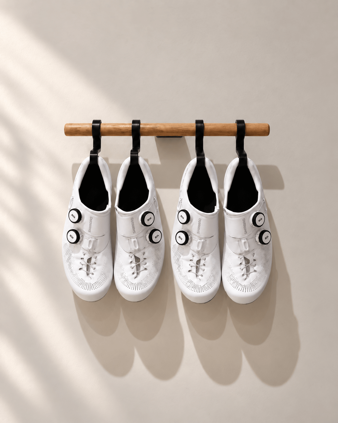 Bar 400 with shoe hooks holding two pairs of white cycling shoes on a lacquered oak rod